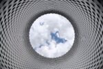 A circular structure with a hole in the centre leading to a view of the sky.