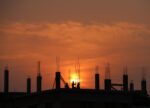 Sunset behind the silhouette of a building site